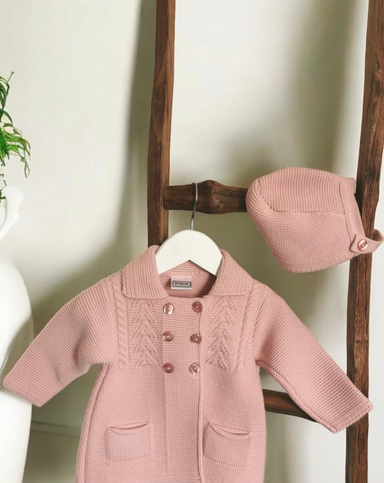 Knitted double breasted coat for baby girl. Front buttoning with textured pattern, comes with matching bonnet.