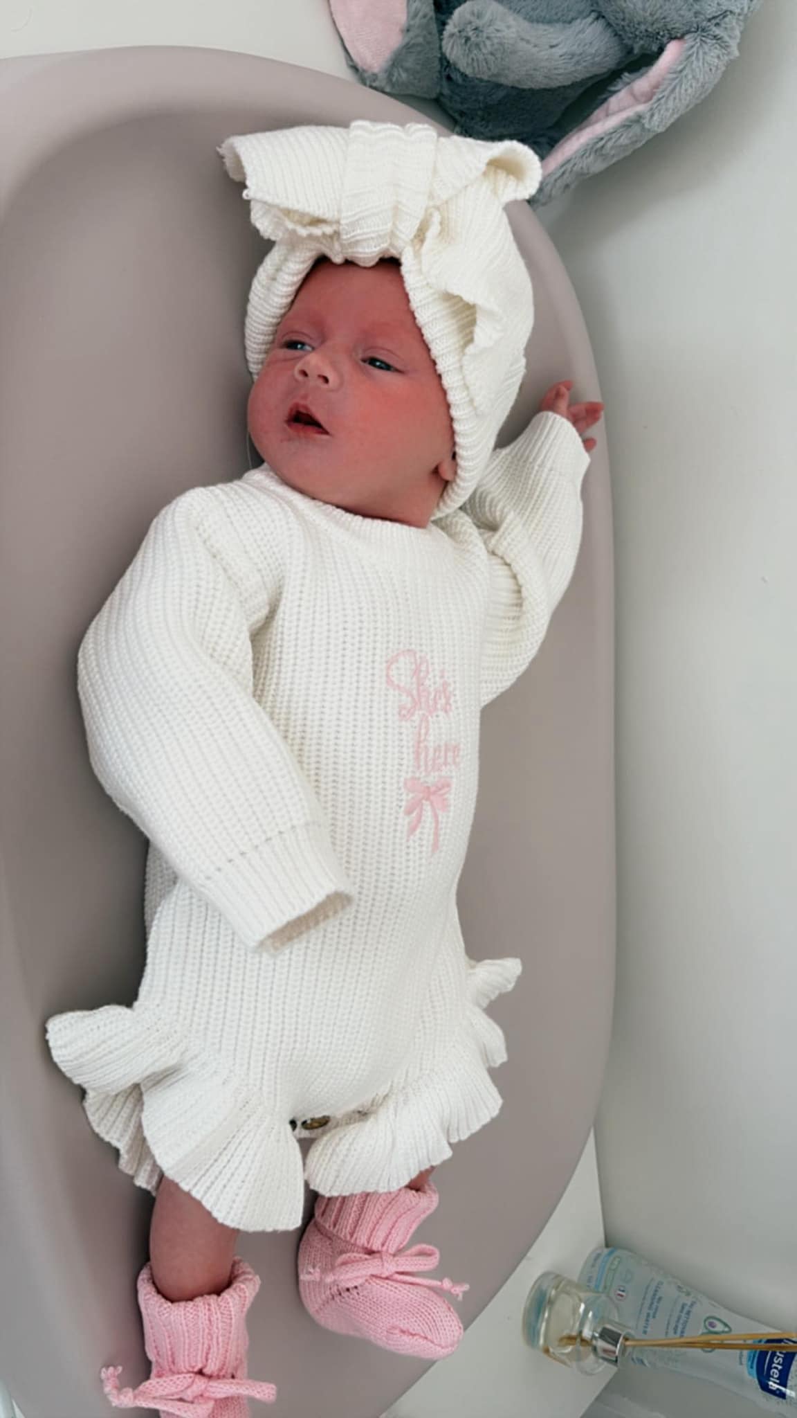 Baby girl knitted romper with she’s here embroidered design with bow detail