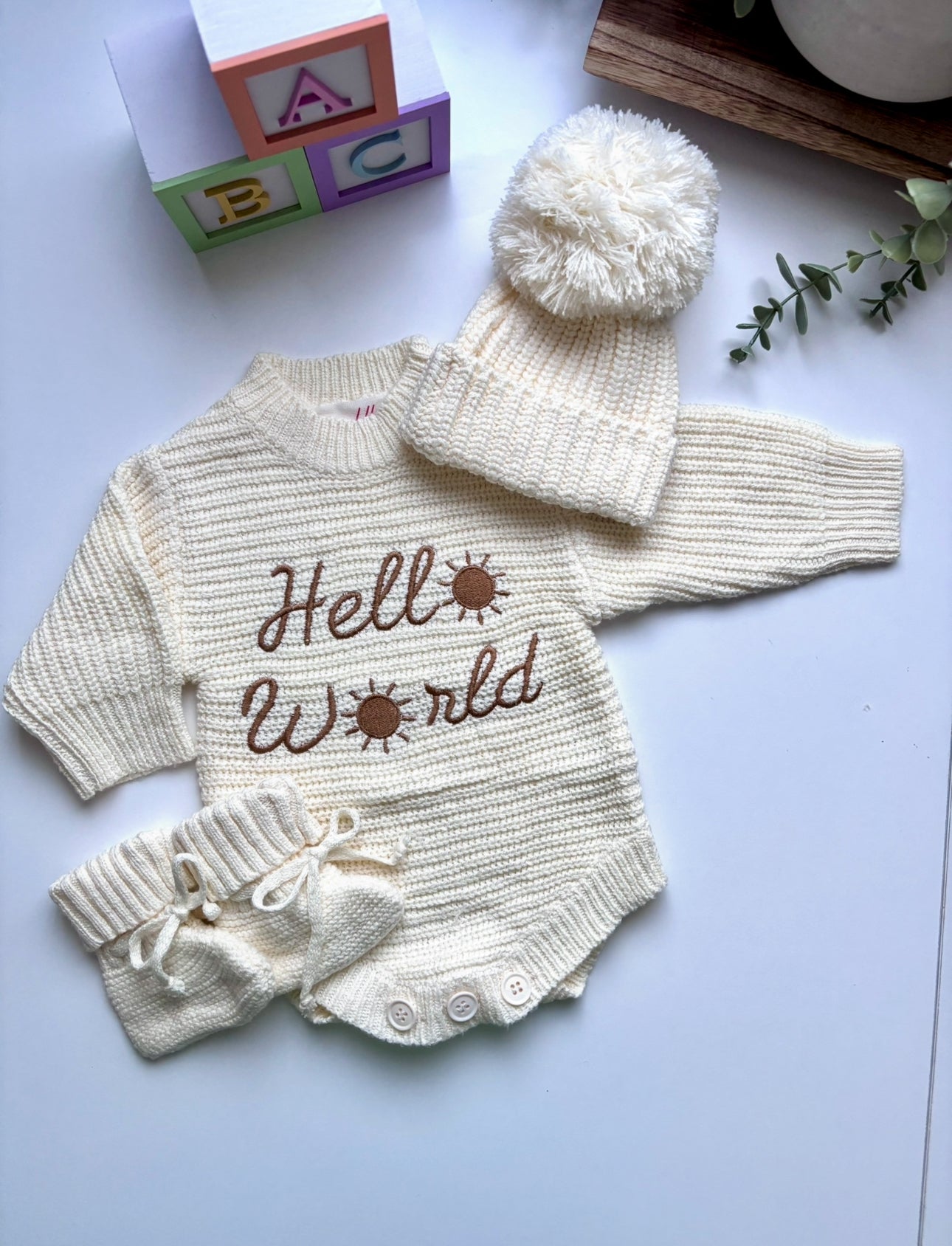 Baby knitted romper, booties and beanie set