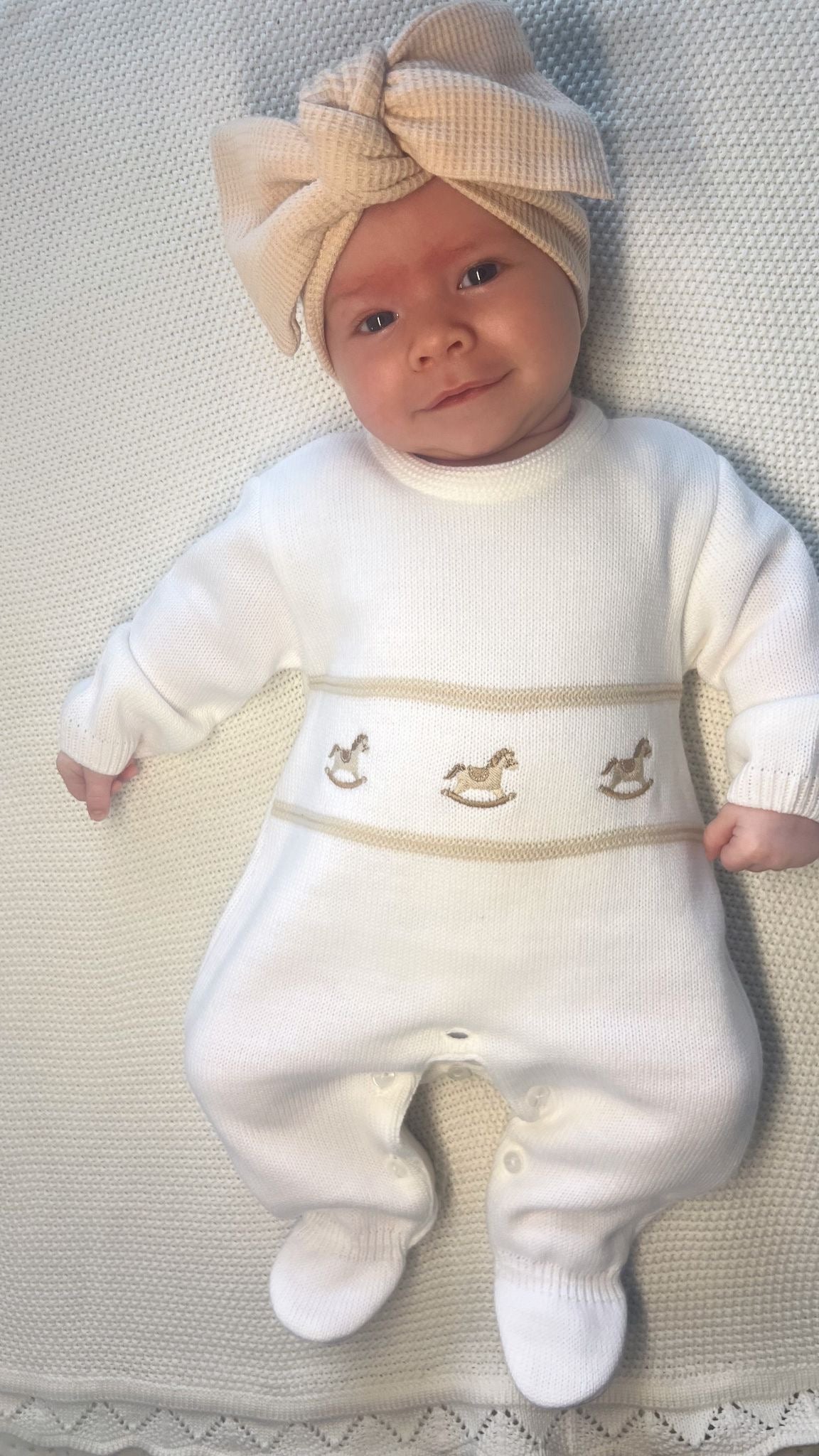 Unisex knitted baby onesie with rocking horse design 