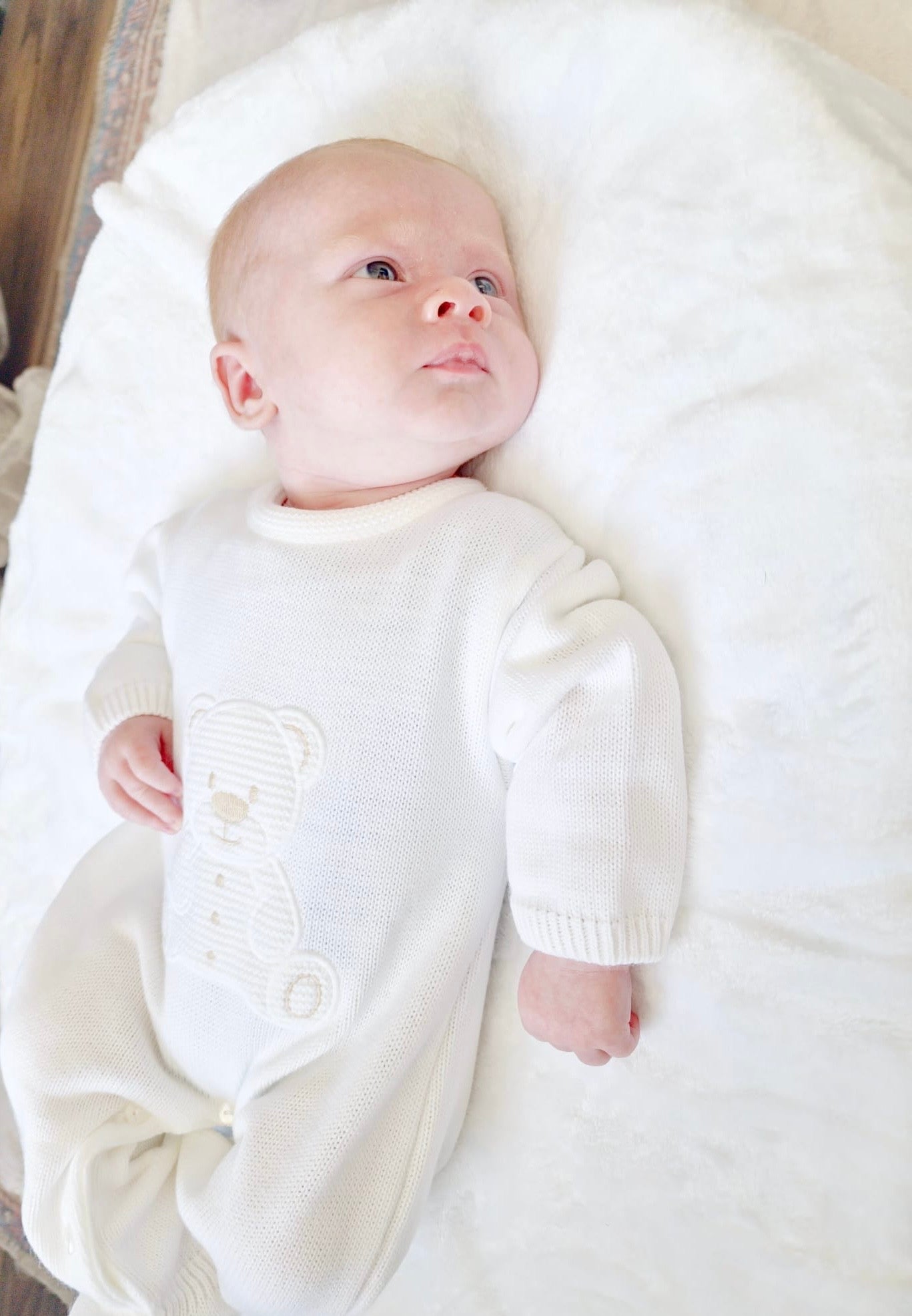 Adorable knitted onesie with embroidered teddy detail from Dandelion.  Unisex.