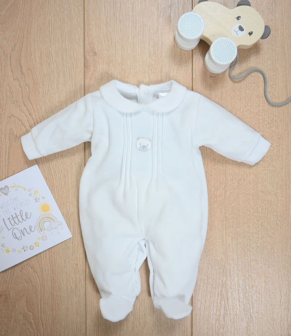 White bear velour baby sleepsuit shown as a flat lay, highlighting soft fabric and classic design