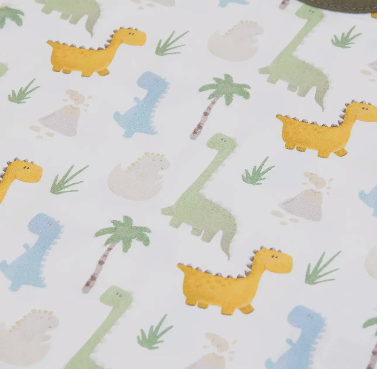 Close-up of the playful animal print fabric on the baby T-shirt from the olive green muslin dungarees set