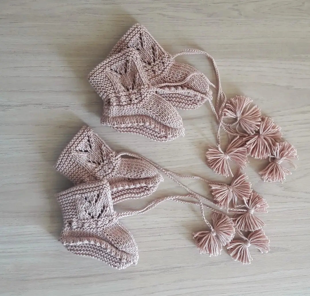 Handknit organic cotton baby booties designed to match a Victorian heirloom baby set