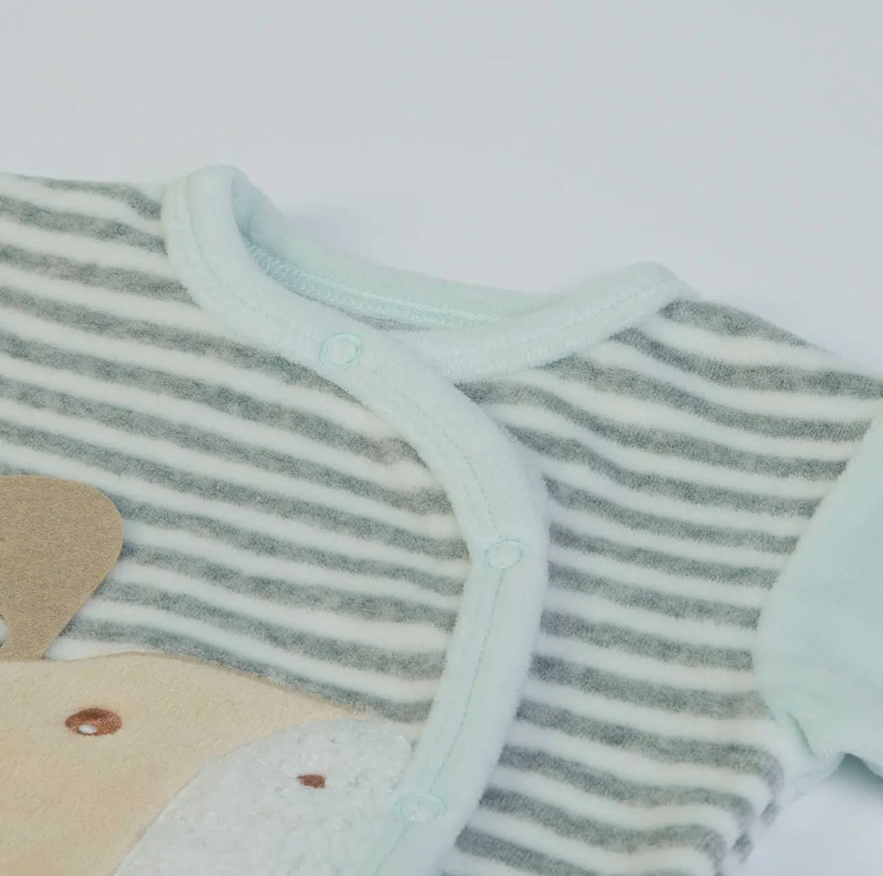 Close-up of the mint and grey velour baby grow neckline, showing soft trim and comfortable fastening