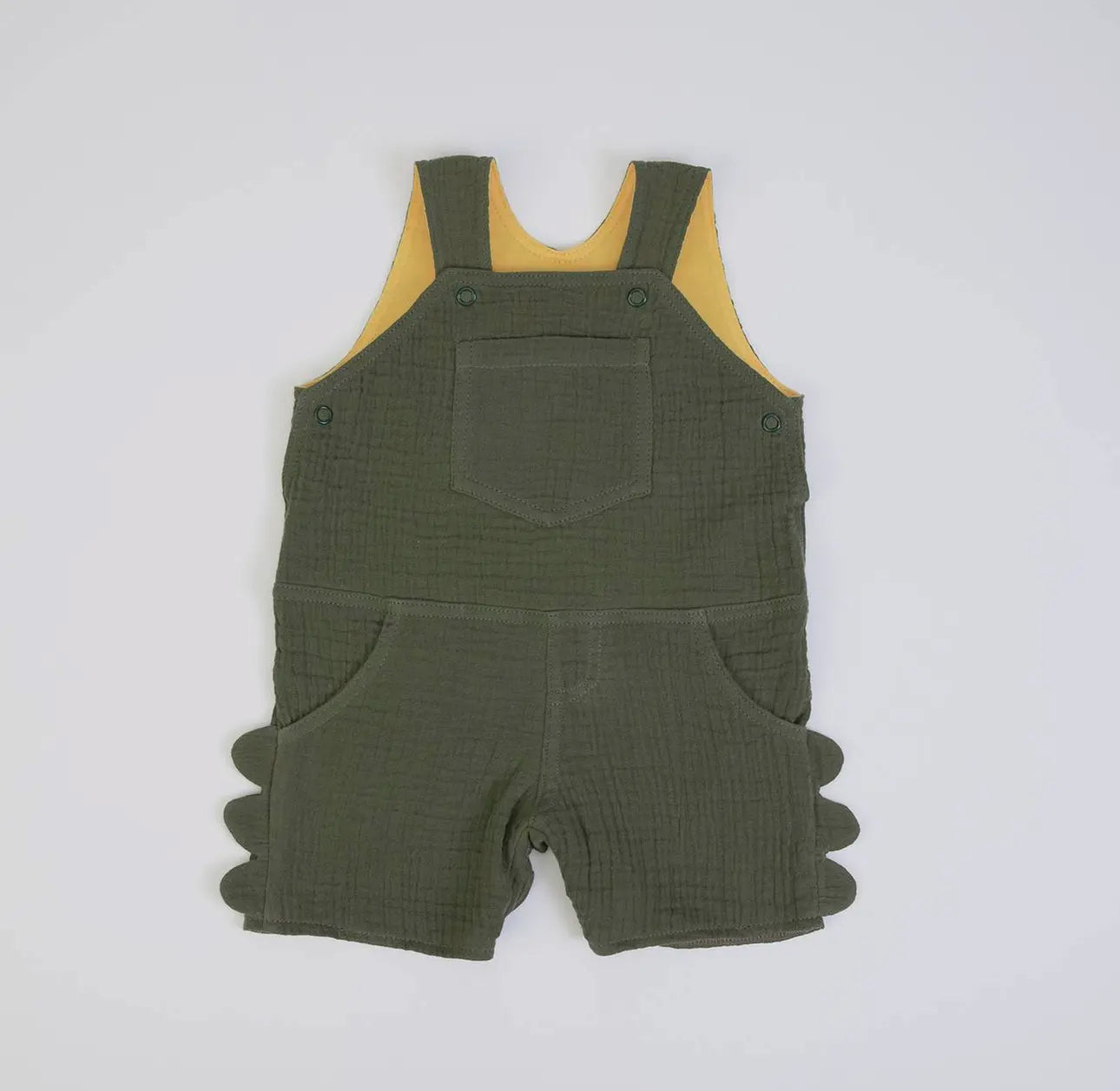 Front view of olive green muslin baby dungarees shown as a flat lay