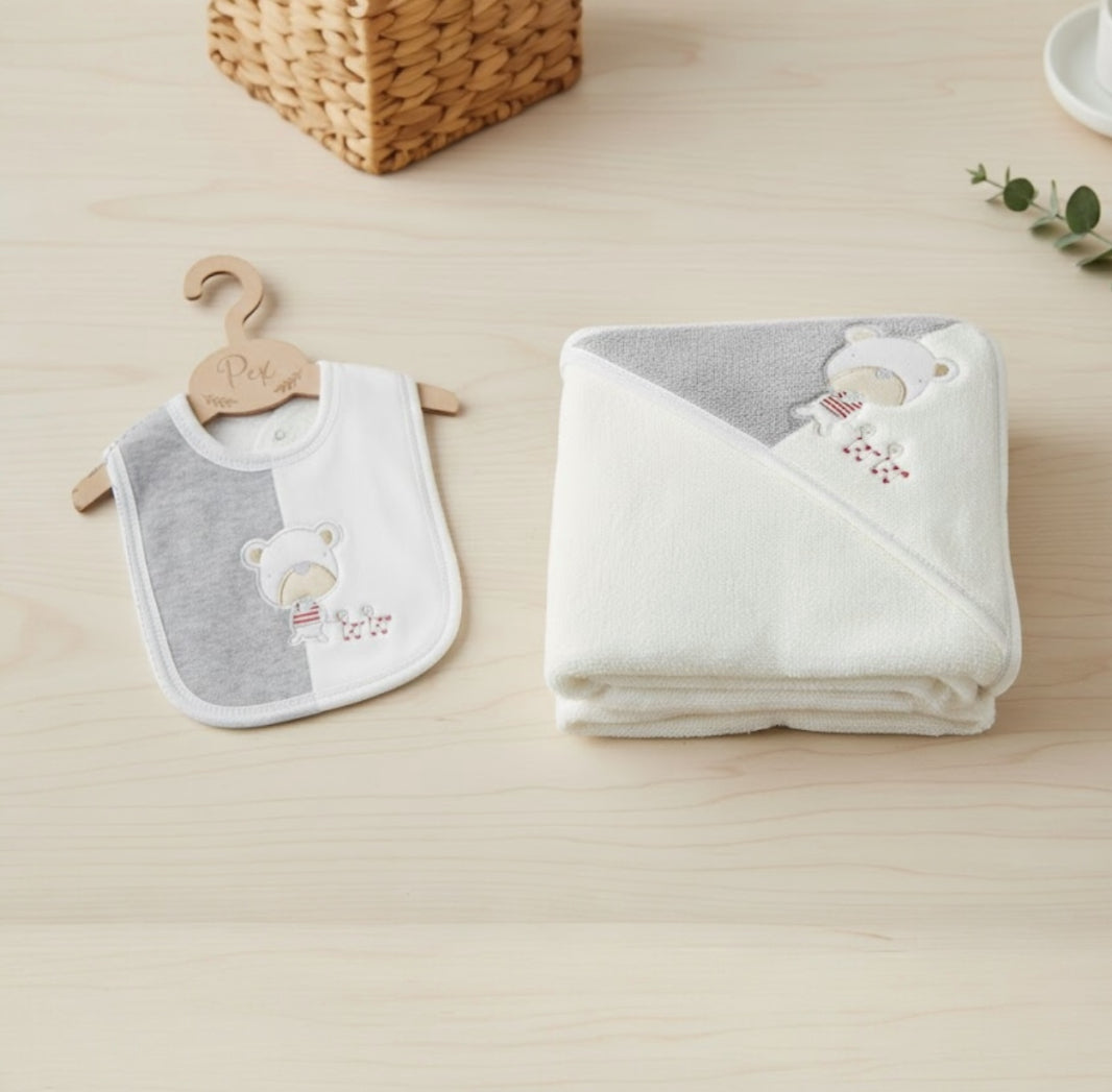 Flat lay of the Playtime 3 piece baby bundle including babygrow, hooded towel and matching bib