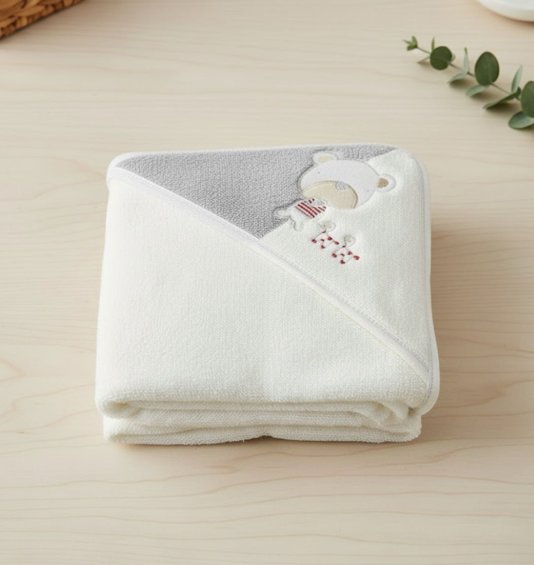 Folded hooded baby towel from the Playtime 3 piece bundle, showing soft fabric and embroidered detail