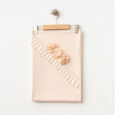 Flat lay view of the Rosalie Blossom Blanket in salmon showcasing the elegant texture and pleated edges.